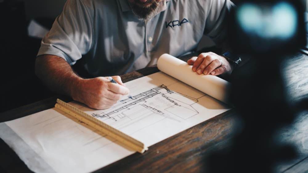 A builder working through drawings by hand